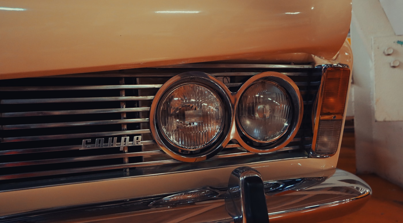 Close view of an older vehicle's headlights